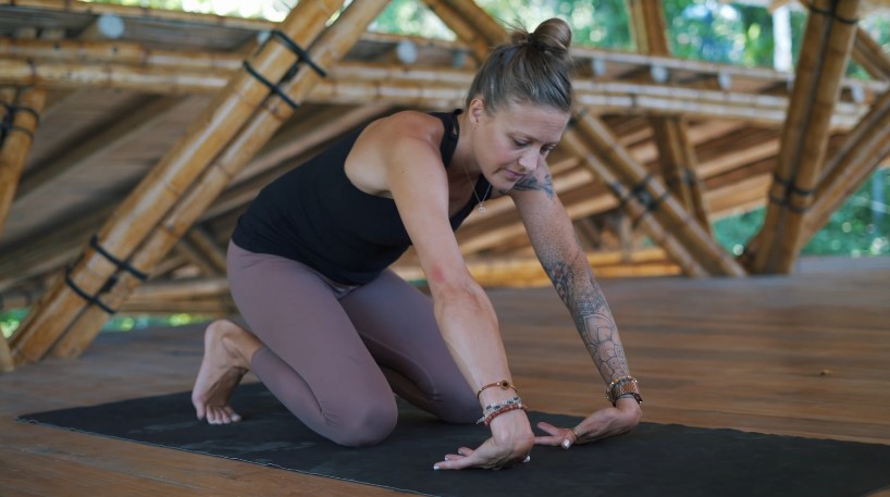 Woman doing wrist warm ups before yoga